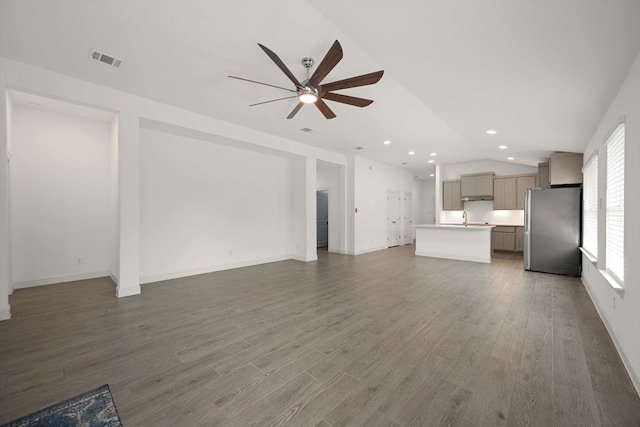 21203 Santa Rosa Ave, Lago Vista, TX 78645 - unfurnished living room with ceiling fan, lofted ceiling, wood finished floors, and recessed lighting