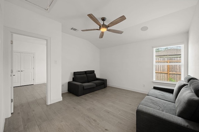 21203 Santa Rosa Ave, Lago Vista, TX 78645 - living room with ceiling fan, light wood finished floors, vaulted ceiling, and attic access
