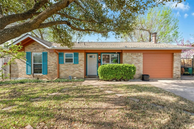 ranch-style house with a front lawn, driveway, a garage, and brick siding
