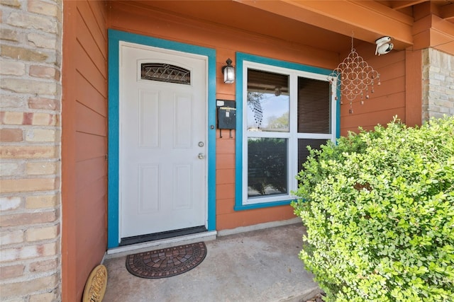 property entrance featuring brick siding