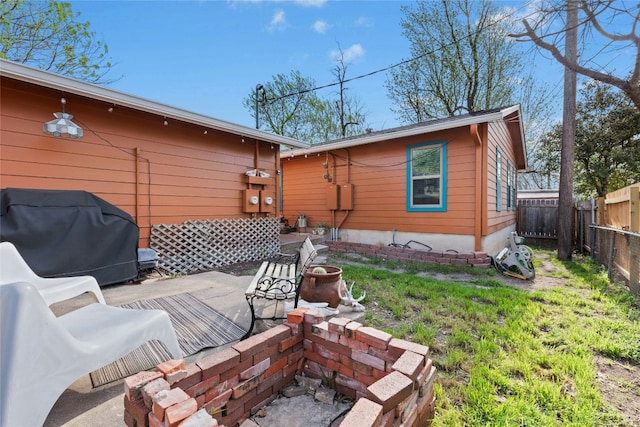 rear view of property featuring a fenced backyard and a patio area