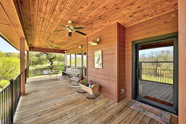 wooden deck with a ceiling fan