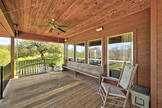 wooden terrace featuring ceiling fan
