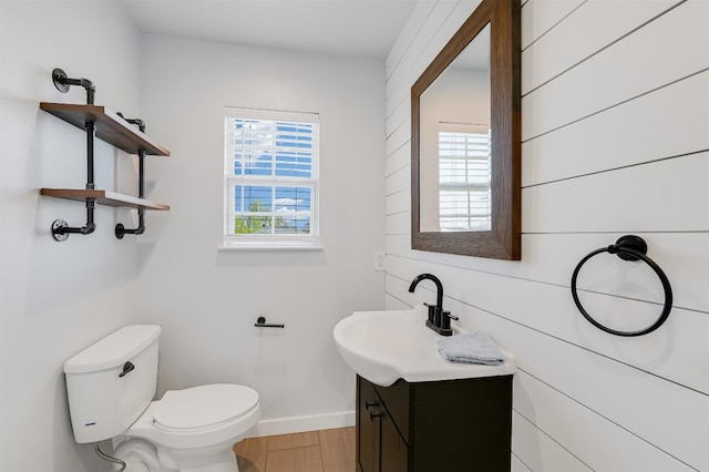 155 Travis Ln, Spicewood, TX 78669 - bathroom with vanity, toilet, baseboards, and wood finished floors