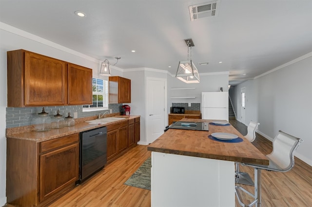 155 Travis Ln, Spicewood, TX 78669 - kitchen featuring black appliances, a sink, backsplash, light wood-type flooring, and wood counters
