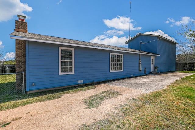 155 Travis Ln, Spicewood, TX 78669 - rear view of property featuring a chimney