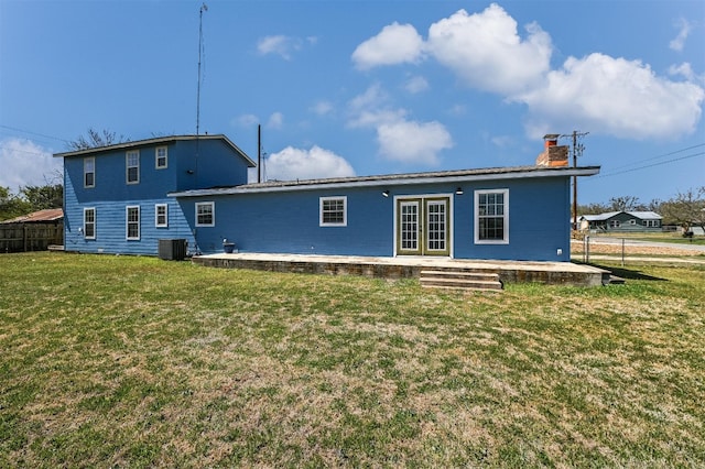 155 Travis Ln, Spicewood, TX 78669 - rear view of house featuring french doors, a chimney, central AC, and a patio area