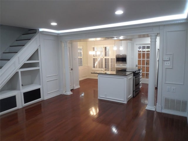 3501 Greystone Dr Unit 3501, Austin, TX 78731 - kitchen with ornate columns, range with electric stovetop, a decorative wall, dark wood finished floors, and white cabinets