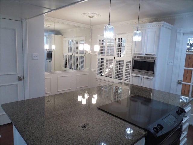 3501 Greystone Dr Unit 3501, Austin, TX 78731 - kitchen with electric range, stainless steel microwave, a spacious island, ornamental molding, and hanging light fixtures