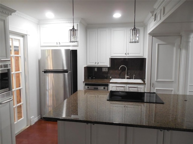 3501 Greystone Dr Unit 3501, Austin, TX 78731 - kitchen with appliances with stainless steel finishes, tasteful backsplash, white cabinets, decorative light fixtures, and dark stone counters