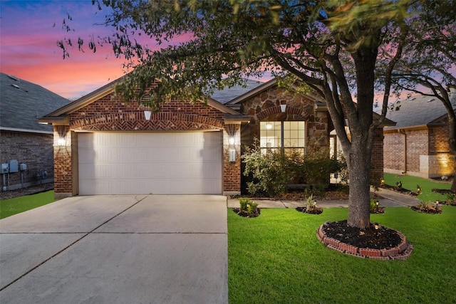 471 Bayou Bend Dr, Buda, TX 78610 - view of front of house featuring brick siding, driveway, a garage, and a front lawn