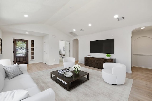 471 Bayou Bend Dr, Buda, TX 78610 - living room with arched walkways, vaulted ceiling, light wood-type flooring, recessed lighting, and baseboards