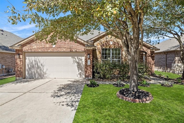 471 Bayou Bend Dr, Buda, TX 78610 - view of front of home with brick siding, a garage, concrete driveway, and a front lawn