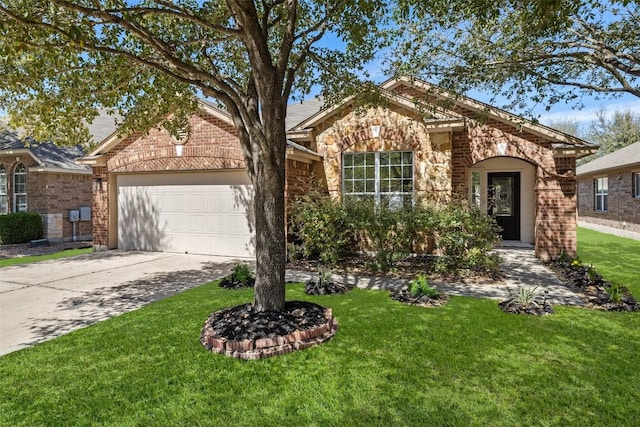 471 Bayou Bend Dr, Buda, TX 78610 - view of front facade with brick siding, an attached garage, driveway, and a front yard