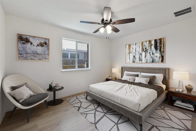 471 Bayou Bend Dr, Buda, TX 78610 - bedroom with light wood-style floors, baseboards, and a ceiling fan
