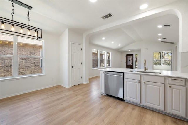 471 Bayou Bend Dr, Buda, TX 78610 - kitchen with dishwasher, a sink, arched walkways, lofted ceiling, and light wood finished floors