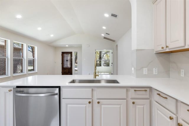 471 Bayou Bend Dr, Buda, TX 78610 - kitchen with stainless steel dishwasher, vaulted ceiling, plenty of natural light, a sink, and light countertops