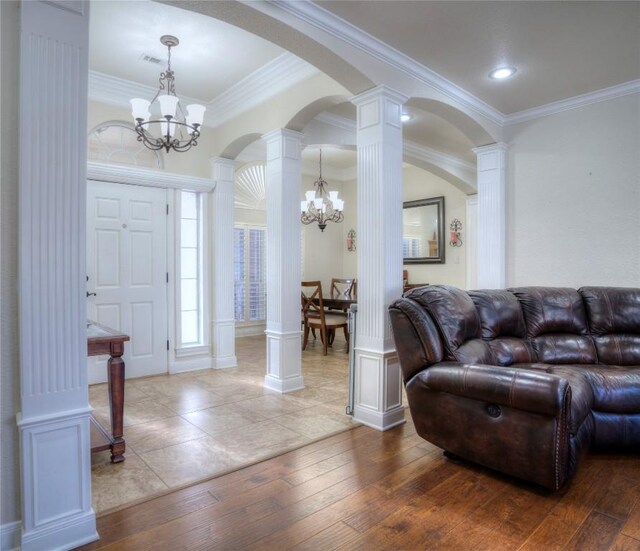 4209 N Sunflower Ln, Temple, TX 76502 - foyer entrance featuring a chandelier, ornate columns, arched walkways, ornamental molding, and hardwood / wood-style flooring