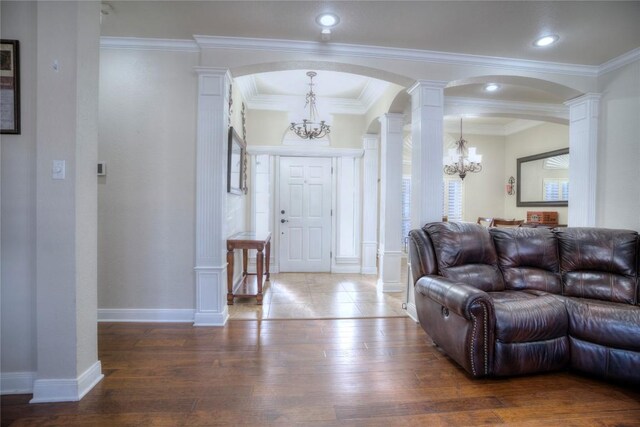 4209 N Sunflower Ln, Temple, TX 76502 - living room with a chandelier, arched walkways, ornate columns, dark wood-style floors, and crown molding