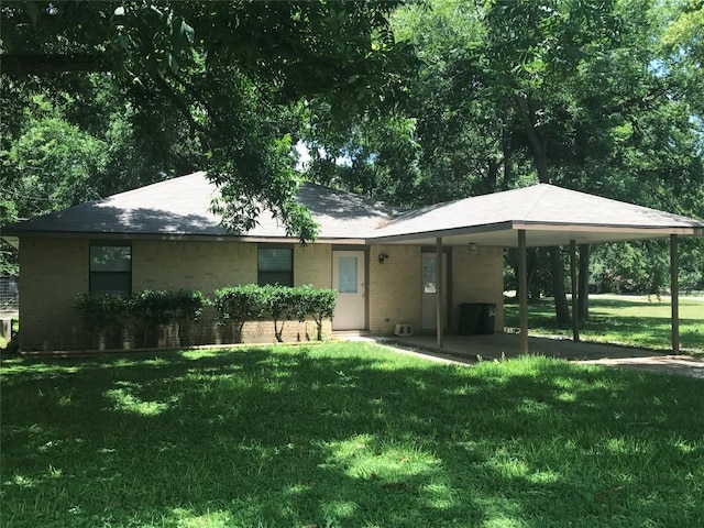 rear view of house with a yard and a carport
