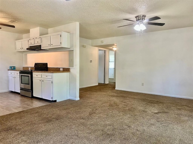 kitchen featuring ceiling fan, dark carpet, electric range, a textured ceiling, and white cabinets