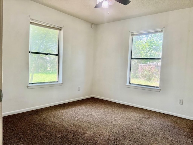 spare room featuring carpet floors, ceiling fan, and baseboards