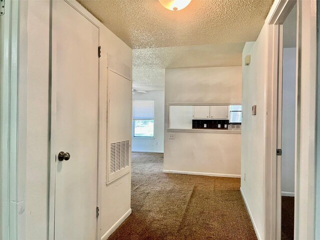302 Harris St, Smithville, TX 78957 - hallway featuring a textured ceiling, carpet flooring, and baseboards