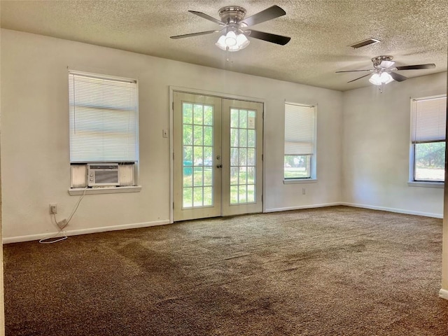 unfurnished room featuring a ceiling fan, carpet, a textured ceiling, cooling unit, and french doors
