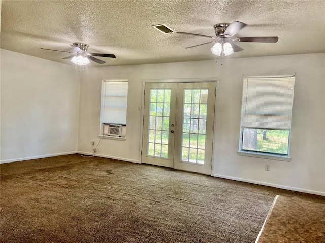 302 Harris St, Smithville, TX 78957 - carpeted empty room with a ceiling fan, french doors, a textured ceiling, baseboards, and cooling unit