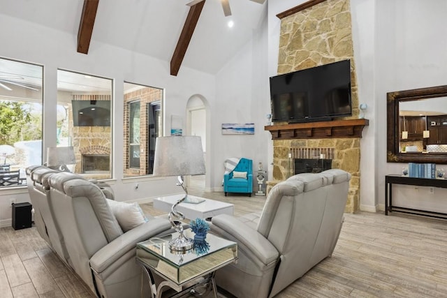 3801 Panther Hall, Leander, TX 78641 - living area featuring ceiling fan, wood finished floors, beam ceiling, a stone fireplace, and arched walkways