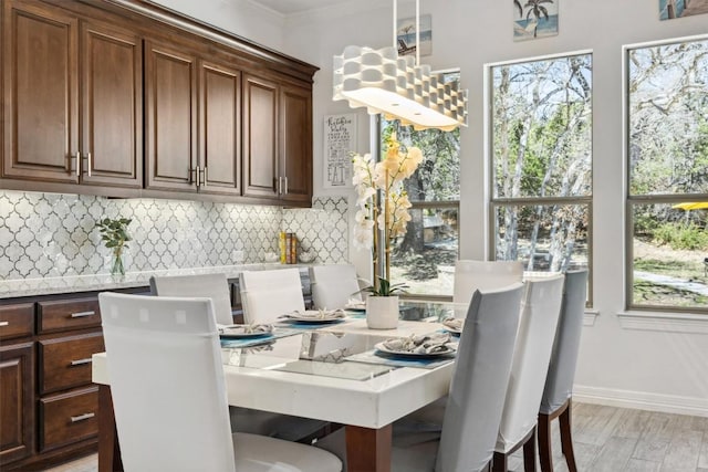 3801 Panther Hall, Leander, TX 78641 - dining space featuring plenty of natural light and crown molding
