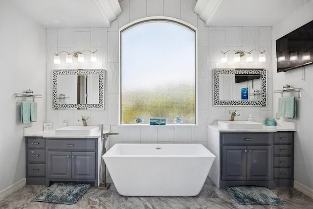 3801 Panther Hall, Leander, TX 78641 - bathroom with two vanities and a freestanding bath