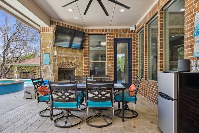 3801 Panther Hall, Leander, TX 78641 - view of patio / terrace featuring ceiling fan, an outdoor stone fireplace, outdoor dining area, and a hot tub