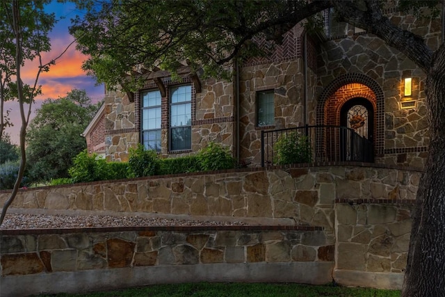 3801 Panther Hall, Leander, TX 78641 - exterior entry at dusk featuring stone siding