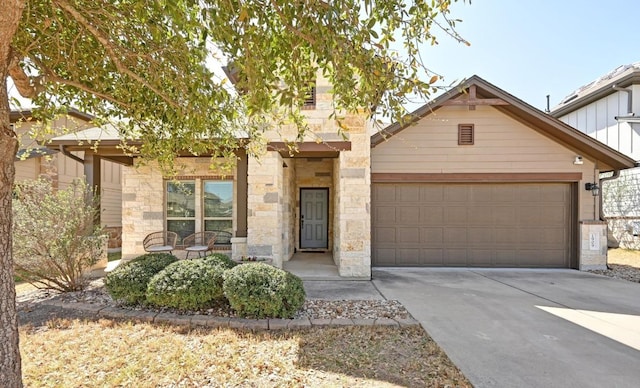 1909 Bobbywoods Ln, Manchaca, TX 78652 - view of front of property featuring a garage, driveway, and stone siding