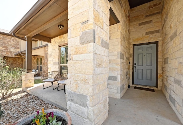 1909 Bobbywoods Ln, Manchaca, TX 78652 - view of exterior entry featuring covered porch and stone siding