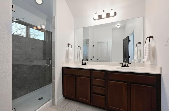 1909 Bobbywoods Ln, Manchaca, TX 78652 - bathroom with double vanity, tile patterned floors, a sink, and a stall shower