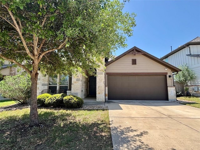 1909 Bobbywoods Ln, Manchaca, TX 78652 - view of front of property with driveway, stone siding, and a garage