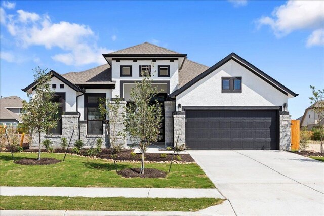 18716 Hopper Ln, Austin, TX 78738 - view of front of home with stone siding, an attached garage, stucco siding, concrete driveway, and a front yard