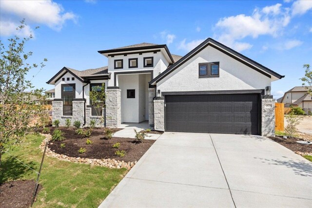 18716 Hopper Ln, Austin, TX 78738 - view of front of property featuring stone siding, concrete driveway, stucco siding, and a garage