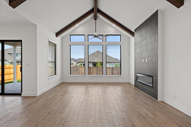 18716 Hopper Ln, Austin, TX 78738 - unfurnished living room with baseboards, a tile fireplace, ceiling fan, and wood finished floors