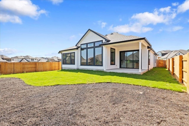 18716 Hopper Ln, Austin, TX 78738 - rear view of property featuring a fenced backyard, a patio area, stucco siding, and a yard