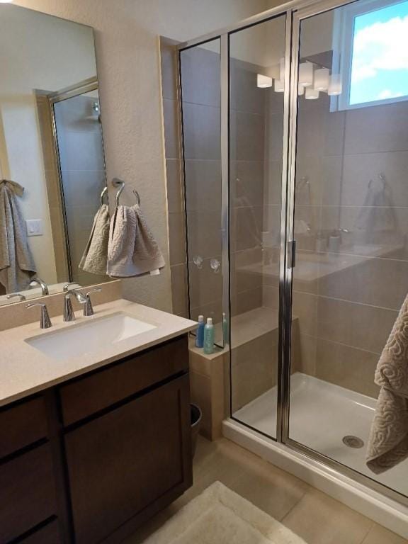 1717 Roseburg Dr, Austin, TX 78754 - full bath with vanity, tile patterned floors, and a shower stall
