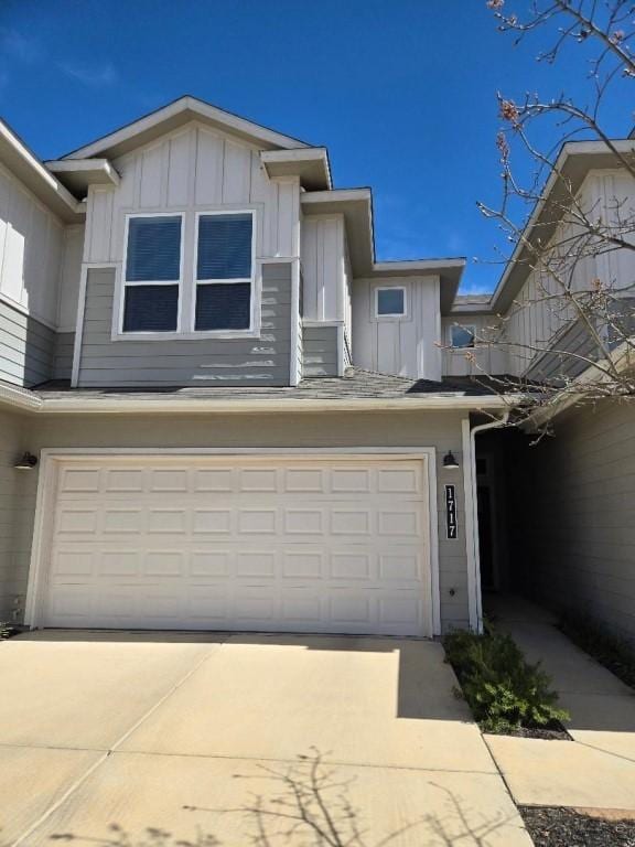 1717 Roseburg Dr, Austin, TX 78754 - townhome / multi-family property with driveway, an attached garage, and board and batten siding