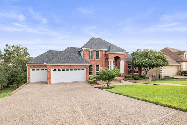 2807 Round Table Rd, Austin, TX 78746 - view of front of house with driveway, brick siding, a front lawn, and roof with shingles
