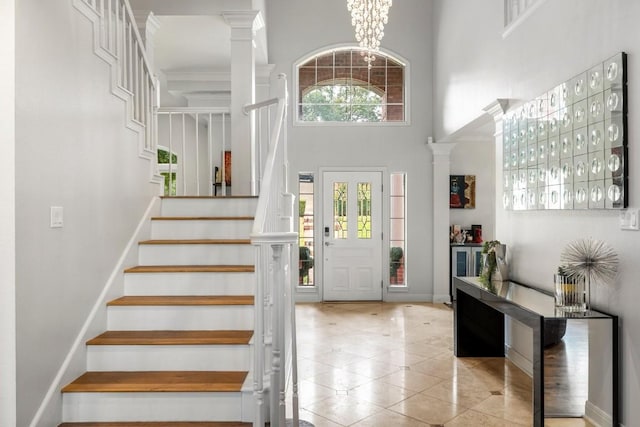 2807 Round Table Rd, Austin, TX 78746 - entrance foyer with a high ceiling, stairs, tile patterned floors, and decorative columns