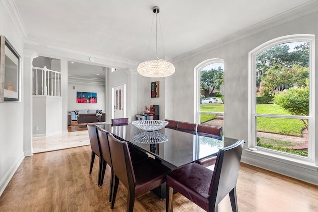 2807 Round Table Rd, Austin, TX 78746 - dining space with wood finished floors, ornamental molding, decorative columns, and a chandelier