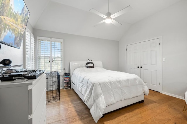 2807 Round Table Rd, Austin, TX 78746 - bedroom with light wood-style flooring, vaulted ceiling, a closet, and ceiling fan