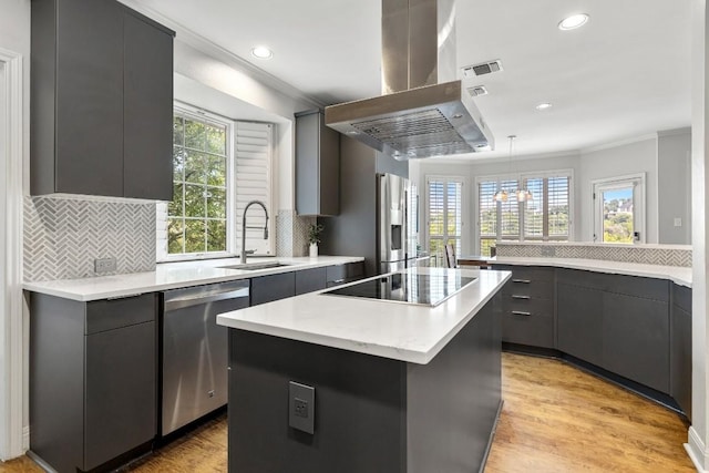 2807 Round Table Rd, Austin, TX 78746 - kitchen featuring appliances with stainless steel finishes, island exhaust hood, crown molding, modern cabinets, and light countertops