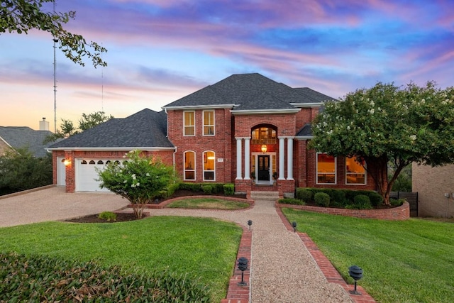 2807 Round Table Rd, Austin, TX 78746 - view of front facade with concrete driveway, brick siding, a front yard, an attached garage, and a shingled roof
